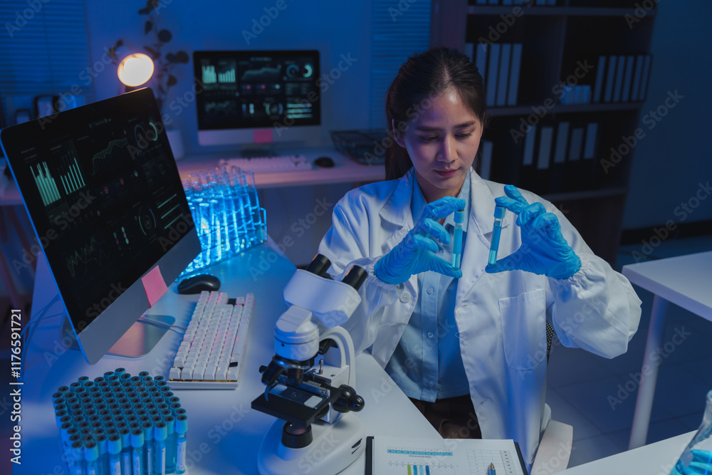Female scientist wearing lab coat and gloves comparing two test tubes ...