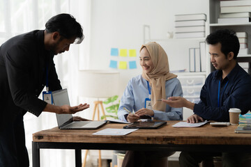 Wall Mural - Collaborative Teamwork: A diverse team of professionals engages in a productive discussion, showcasing collaboration, communication, and a shared workspace.