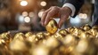 © Wilasinee - Close up shot of a businessman s hand delicately picking up a shimmering golden egg representing the pursuit of wealth success and valuable opportunities  The image conveys a sense of exclusivity