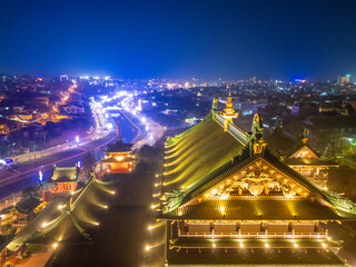 Wall Mural - Aerial night view of Minh Thanh pagoda, a majestic Buddhist architectural structure in Pleiku city, Gia Lai province, Vietnam, text in photo mean Peace, Happy New Year.