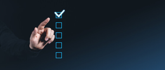 Poster - Hand pointing at glowing checkbox on dark background, checklist concept.
