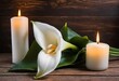 © Iqra - A white calla lily flower next to a lit candle on a wooden background