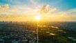 © AucArtStudio - Economic policy reform concept. Sunrise over a vibrant cityscape with green fields and water bodies.