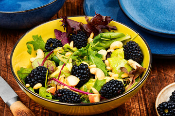 Sticker - Fresh salad bowl with raw blackberries.