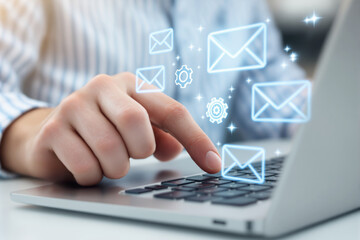 Aufkleber - Person interacting with digital email icons on laptop keyboard, symbolizing online communication and technology concepts.