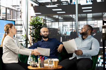 Poster - Diverse businesspeople in startup workplace looking through financial business documents. Workers in office checking accounting figures, finishing tedious paperwork, discussing about data
