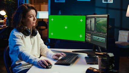 Poster - Video editor analyzing film montage on isolated screen display, editing color grading in office. Post production studio employee working with raw footage on chroma key PC, camera B