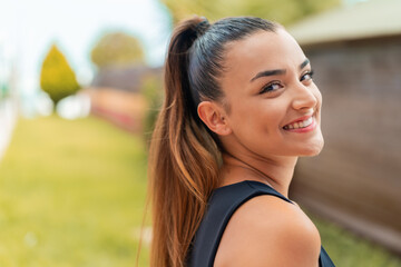 Wall Mural - Young pretty woman at outdoors With happy expression