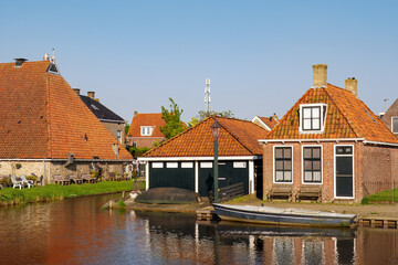 Wall Mural - House with boathouse along Zijlroede canal in old town of Hindeloopen, Friesland, Netherlands