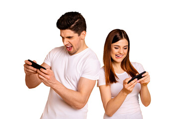 Wall Mural - Portrait of his he her she two nice attractive lovely stylish trendy cheerful cheery positive people enjoying playing app contest isolated over vivid shine bright yellow background