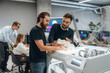 © standret - Communication, finished printed object. People are in the office by the 3d printer