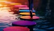 © apichat - A person walks across colorful stepping stones in a serene body of water, creating a vibrant and tranquil scene.