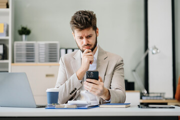 young stressed caucasian businessman working in the office. businessman thinking too much work conce