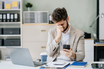 young stressed caucasian businessman working in the office. businessman thinking too much work conce