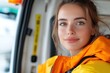 © Pinklife - A content woman in a cozy orange jacket, showcasing a serene expression while posing in a vehicle, reflecting tranquility and a positive spirit.