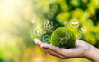 © GamePixel - World environment day, Responsibility for a green planet, Sustainable growth, and global conservation.Businessman holding green world, Sustainable development goals and corporate social responsibility