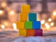© Momina - Colorful baby toy blocks stacked in a tower with soft lighting