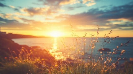 Aufkleber - A serene sunset over the ocean, with grass in the foreground, evoking tranquility.