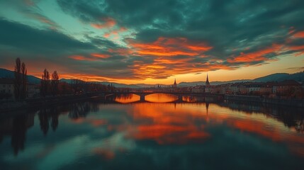 Poster - A vibrant sunset over a river, reflecting colorful clouds and silhouettes of buildings.