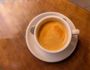 Wall Mural - Coffee Cup on Wooden Café Table