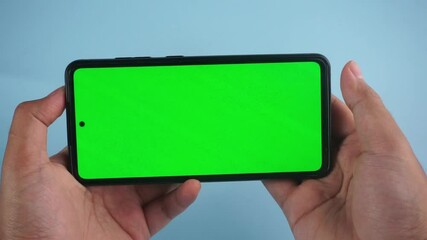 Hand Gestures Watching Videos on Smartphone With Green Screen on Blue Background