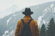 © neiros - With a rugged outdoor jacket, a man gazes up at a mountain vista, embodying a sense of exploration and wonder