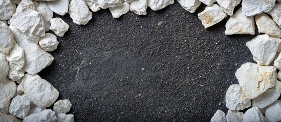 Poster - Dark sand cave backdrop framed with white marble pebbles ideal for showcasing text or creative designs in an elegant setting.