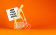 © Dzmitry - Keep your focus going symbol. Concept words Keep your focus going on beautiful white paper. Beautiful orange background. Miniature bicycle. Business and keep your focus going concept. Copy space.