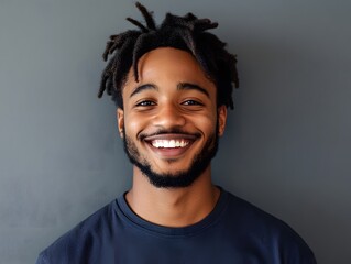 Wall Mural - Smiling young man isolated on gray wall