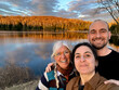 © tessy morelli/Stocksy - UGC POV family selfie by the lake