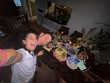 © tessy morelli/Stocksy - UGC POV happy couple selfie at home with party buffet