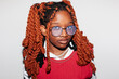 © Viktor Solomin/Stocksy - Unique portrait of an African girl with long twisted hair and glasses