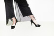 © Colour Laboratory/Stocksy - Person with high classic heels and elegant and festive mesh trousers