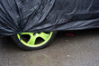 © Basil Pind/Stocksy - Green Car Wheel Under Black Cover