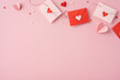 © ActionGP - A collection of red and pink envelopes on a pastel background, adorned with heart-shaped decorations, conveying a feeling of love and romance for Valentine's Day