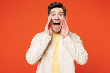 Poster - Young happy man he wear white shirt yellow t-shirt casual clothes scream sharing hot news about sales discount with hands near mouth isolated on plain red orange background studio. Lifestyle concept.