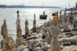 © Irina Bo/Stocksy - Artistic rock stacking along the riverbank on a sunny afternoon