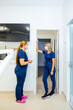 © VICTOR TORRES/Stocksy - Dental Professionals Discussing in the Clinic Hallway