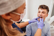 © VICTOR TORRES/Stocksy - Patient Receives Professional Dental Checkup at Modern Clinic