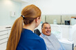 © VICTOR TORRES/Stocksy - Dentist and patient interaction in a bright dental clinic settin