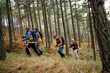© Boris Jovanovic/Stocksy - Four people hiking together in the woods