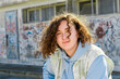 © Anna Fedorova/Stocksy - Curly-haired teenage informal girl
