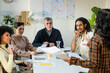 © Jimena Roquero/Stocksy - Diverse Business team in work meeting listening to project leader