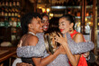 © BONNINSTUDIO/Stocksy - Happy friends hugging and celebrating new year's eve at bar ugc