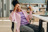 Tired office manager suffering from headache at workplace