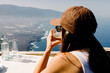 © Adrian Rodd/Stocksy - Female traveler seated at an outdoor table at the Mirador de La Peña