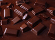 © J.Rynio PHOTOGRAPHY/Stocksy - Chocolate bars melting in dark chocolate