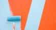 © J.Rynio PHOTOGRAPHY/Stocksy - A paint roller is painting with blue and orange colors indoors