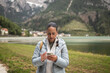 © Lupe Rodriguez/Stocksy - woman in dolomites using mobile phone