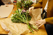 © Ivan Jovanovic/Stocksy - Wrapping a fresh bouquet of flowers